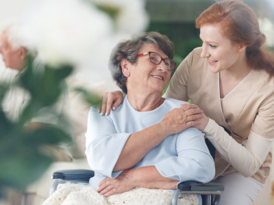 senior woman and caregiver looking at each other